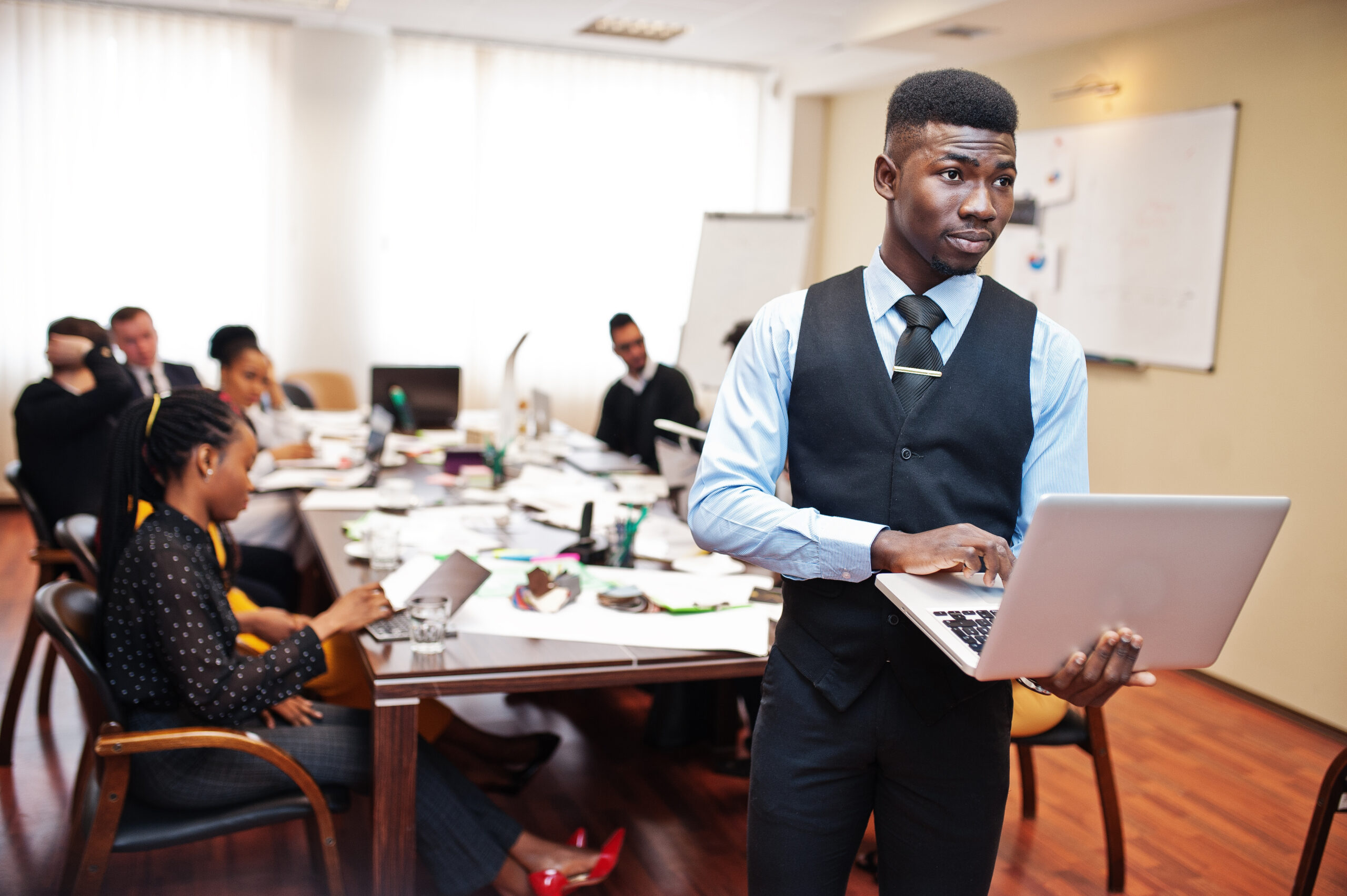 A young business professional taking charge of a team brainstorming session.